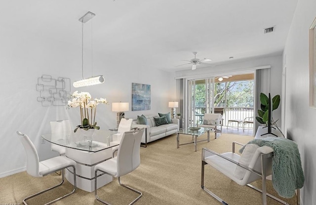 carpeted living room featuring ceiling fan