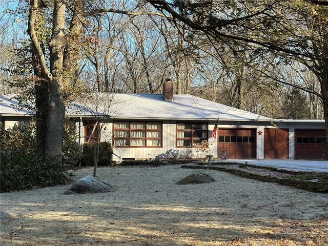 view of front of home featuring a garage and a chimney