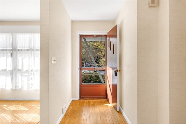 entryway featuring light wood-type flooring and baseboards