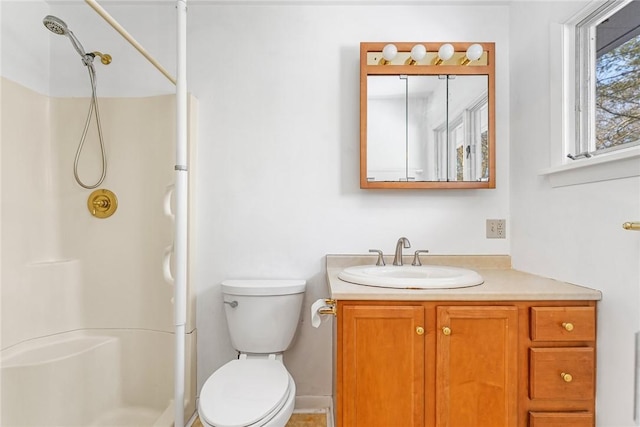 bathroom with vanity, walk in shower, and toilet