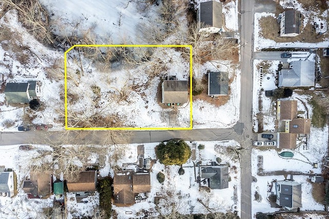 snowy aerial view featuring a residential view