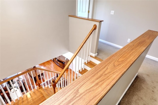 stairs featuring carpet floors and baseboards