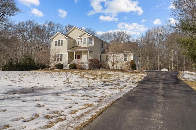 traditional-style home with aphalt driveway