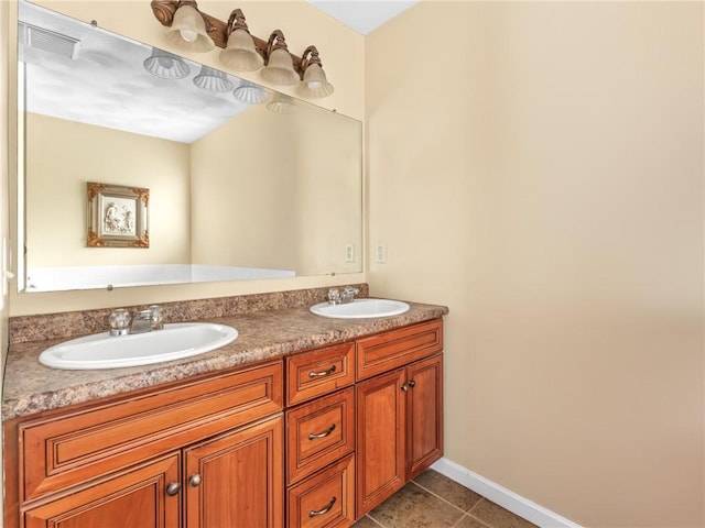 bathroom with tile patterned floors, double vanity, visible vents, and a sink