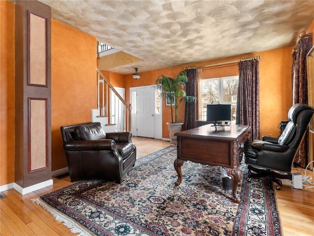 office space with hardwood / wood-style flooring and baseboards