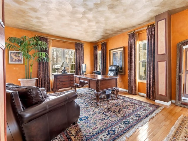 home office featuring light wood-style floors and baseboards