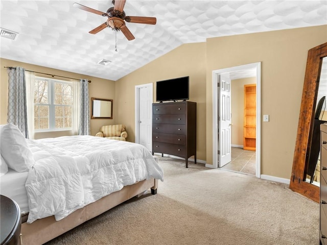 bedroom with visible vents, light colored carpet, baseboards, and lofted ceiling