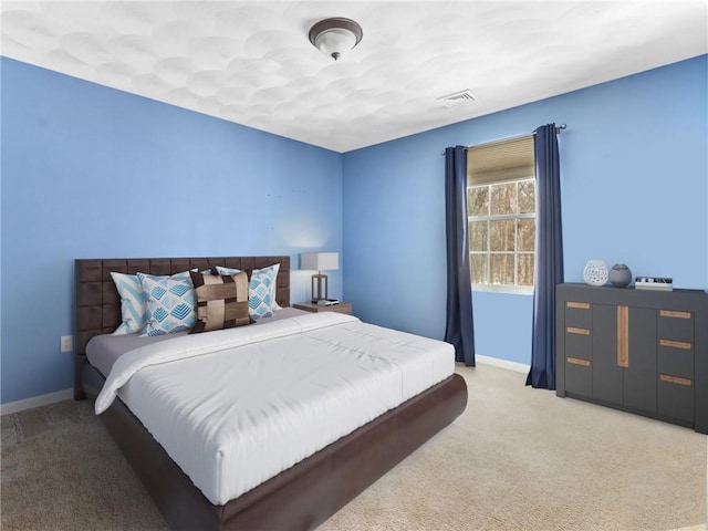 carpeted bedroom featuring visible vents and baseboards