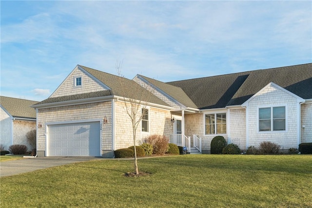 view of front of home with a garage, concrete driveway, a shingled roof, and a front lawn