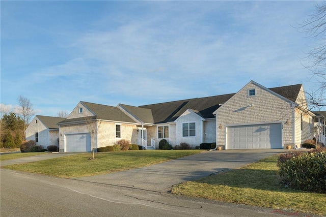 ranch-style house featuring a garage, driveway, and a front lawn