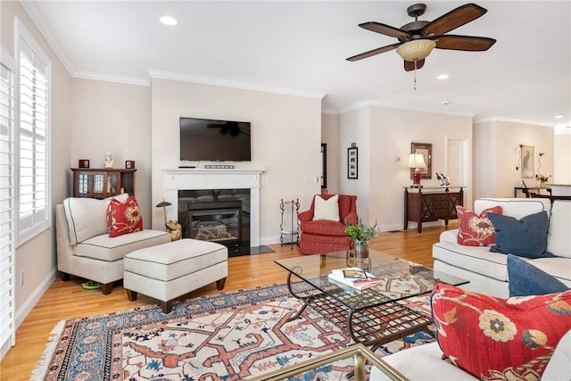 living room with crown molding, plenty of natural light, and light wood finished floors