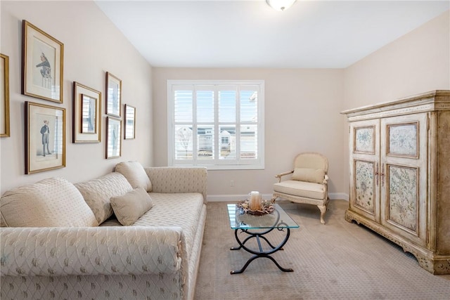 living area featuring carpet and baseboards