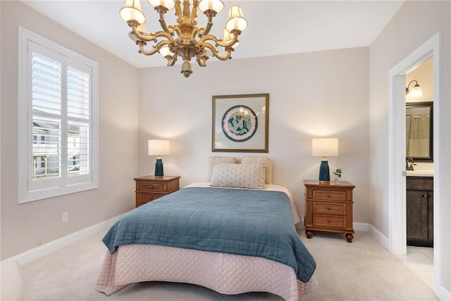 bedroom featuring an inviting chandelier, light carpet, baseboards, and ensuite bathroom