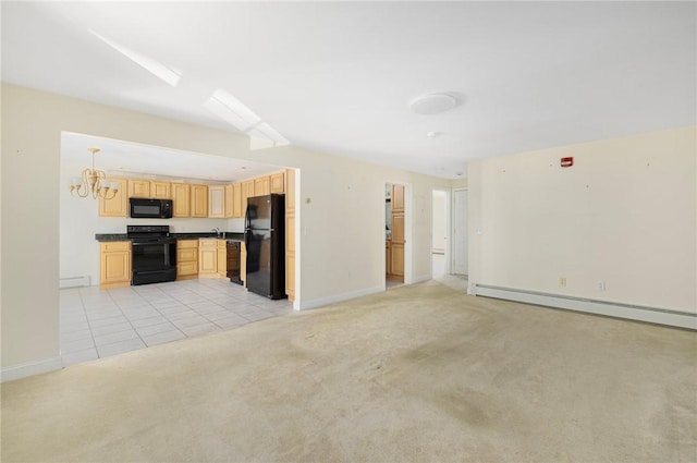 kitchen featuring light colored carpet, a baseboard heating unit, light brown cabinetry, black appliances, and a chandelier