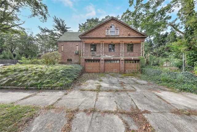 bungalow featuring an attached garage, driveway, and brick siding