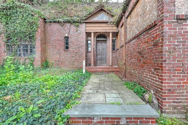 doorway to property with brick siding