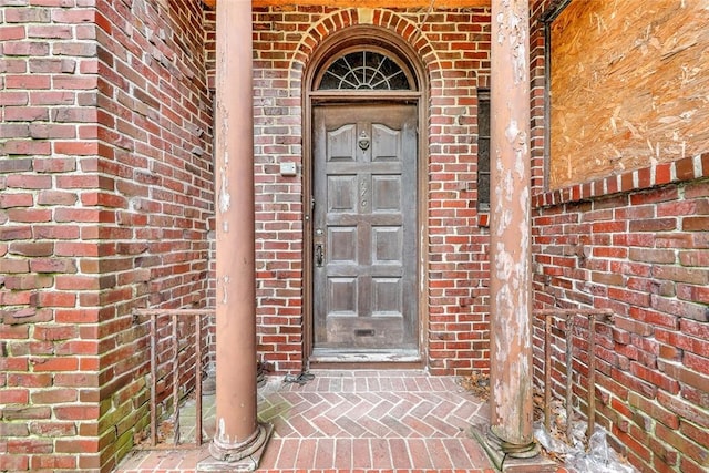 entrance to property with brick siding