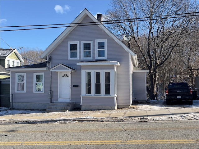 bungalow-style house with entry steps and a chimney