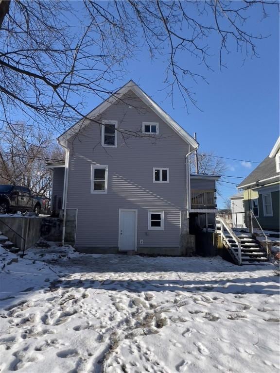 view of snow covered rear of property