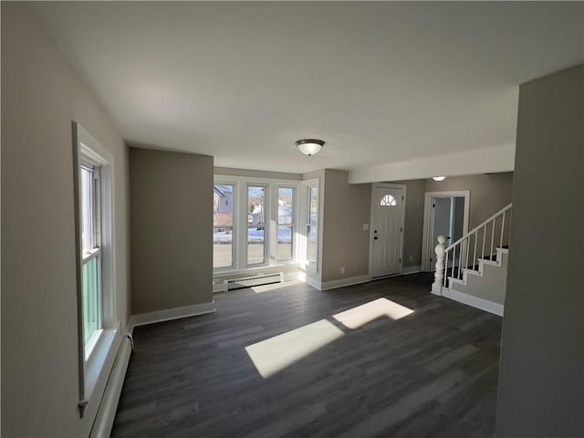 entrance foyer featuring a baseboard heating unit, baseboards, stairs, baseboard heating, and dark wood finished floors