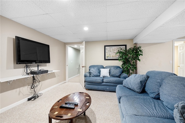 carpeted living room featuring a paneled ceiling and baseboards