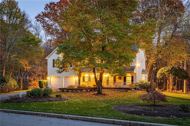 view of front of home featuring an attached garage and a front lawn