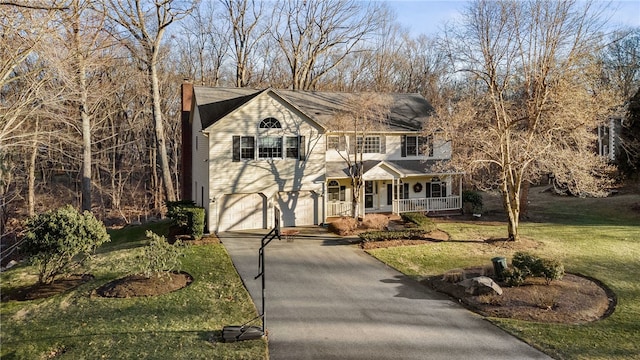 view of front facade featuring a porch, concrete driveway, an attached garage, and a front lawn