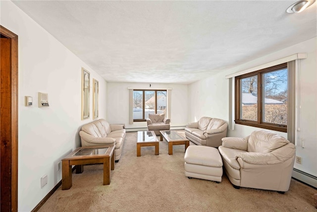 living area with baseboards, light colored carpet, and baseboard heating