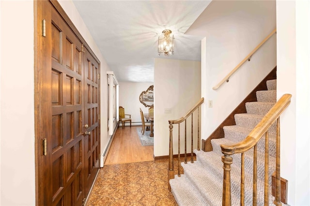 interior space with baseboards, stairs, and a chandelier