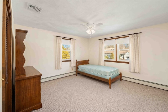 bedroom featuring carpet, a baseboard radiator, visible vents, and ceiling fan