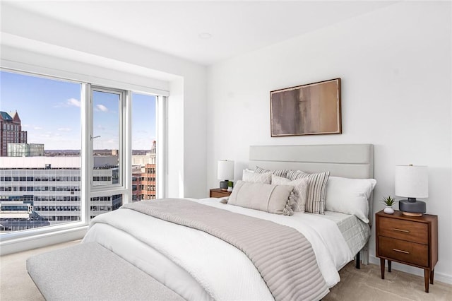 carpeted bedroom with access to exterior and a view of city