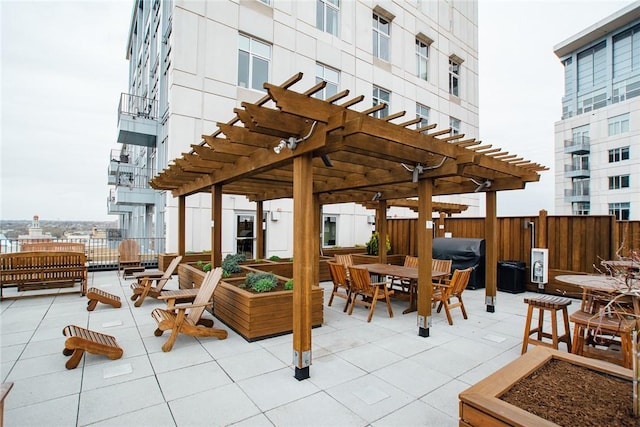 view of patio with fence, a pergola, and area for grilling