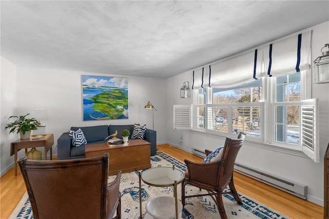 interior space with a baseboard radiator, wood finished floors, and baseboards