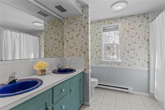 full bathroom featuring wallpapered walls, a baseboard heating unit, a sink, and a wainscoted wall