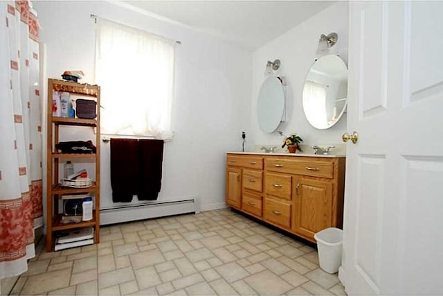 bathroom featuring baseboard heating and vanity