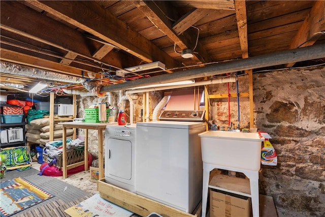 unfinished below grade area with a sink and independent washer and dryer