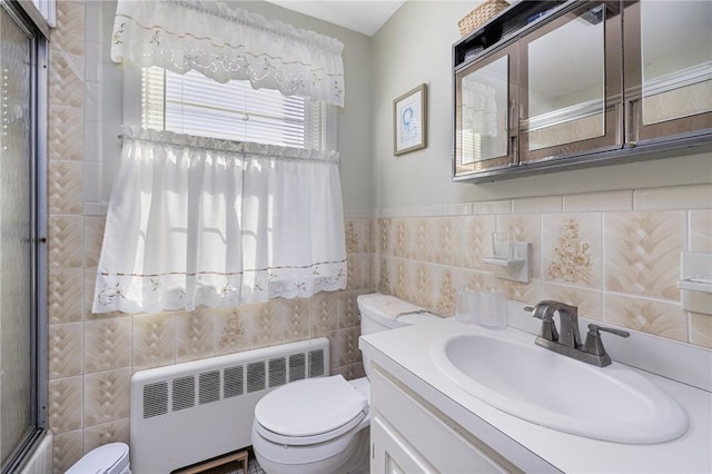 bathroom with toilet, tile walls, radiator heating unit, and vanity