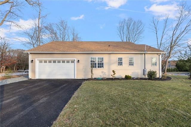 view of front of home featuring a garage, aphalt driveway, and a front lawn