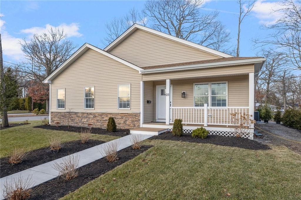 25 Summit Dr, Cranston, RI 02920 - view of front of property featuring a front yard, stone siding, and covered porch