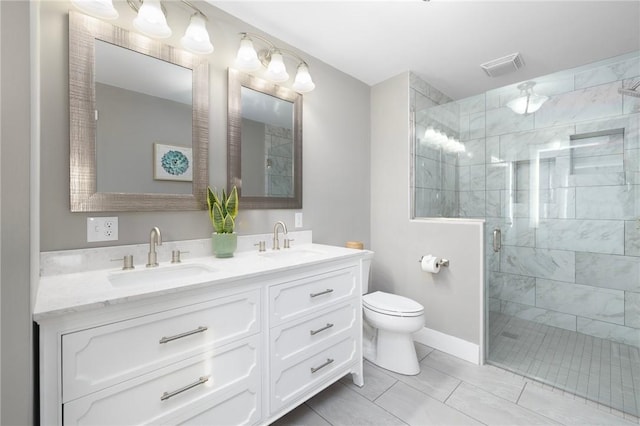 full bathroom with visible vents, a sink, a shower stall, and double vanity