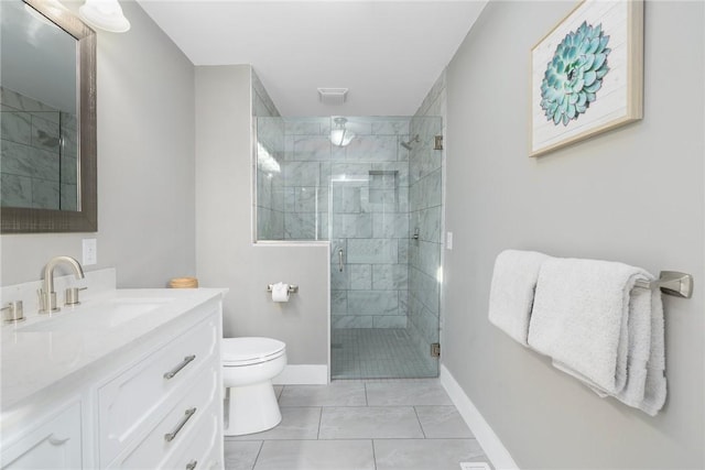 bathroom with baseboards, toilet, tile patterned flooring, vanity, and a shower stall