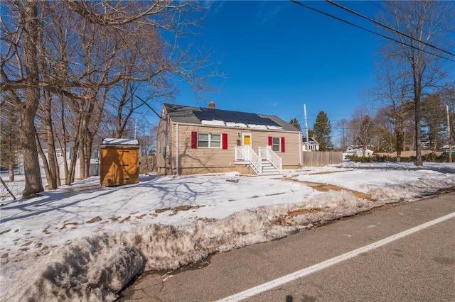 bungalow-style home featuring roof mounted solar panels