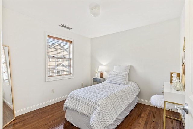 bedroom featuring visible vents, wood finished floors, and baseboards