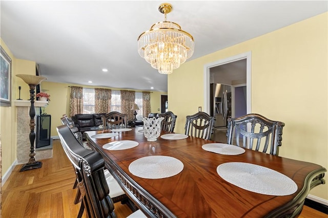 dining area featuring baseboards, parquet floors, recessed lighting, and a notable chandelier