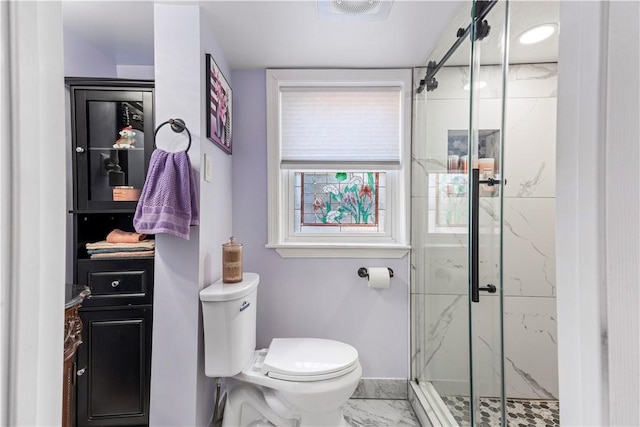 bathroom featuring toilet, marble finish floor, a marble finish shower, and visible vents