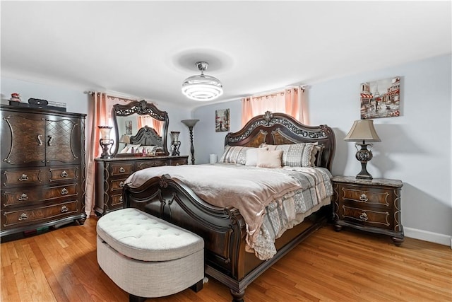 bedroom featuring light wood-style flooring and baseboards