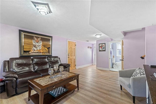 living area featuring light wood-style flooring and baseboards