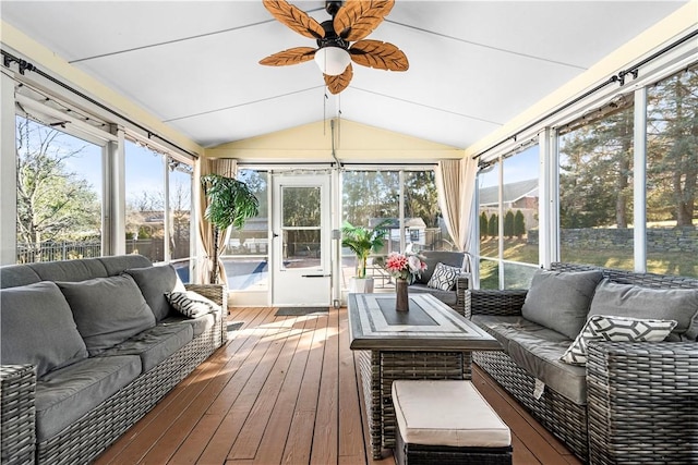 sunroom / solarium with plenty of natural light, vaulted ceiling, and a ceiling fan