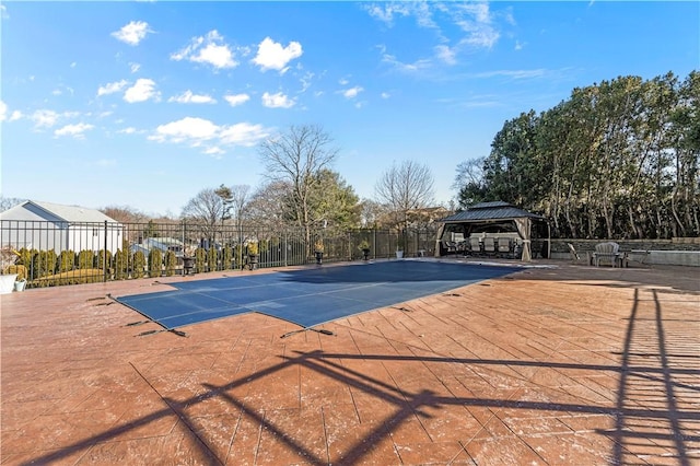 view of swimming pool featuring fence and a gazebo