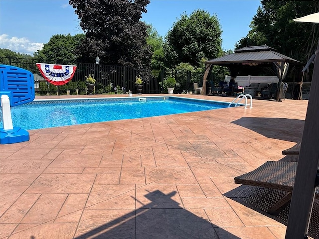 view of pool with a fenced in pool, fence, a patio, and a gazebo